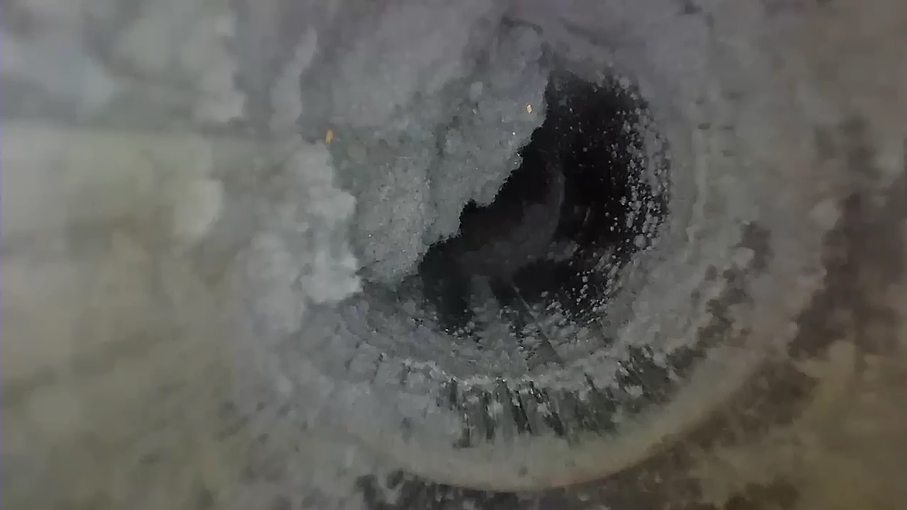 Clogged dryer vent before professional cleaning with heavy lint buildup